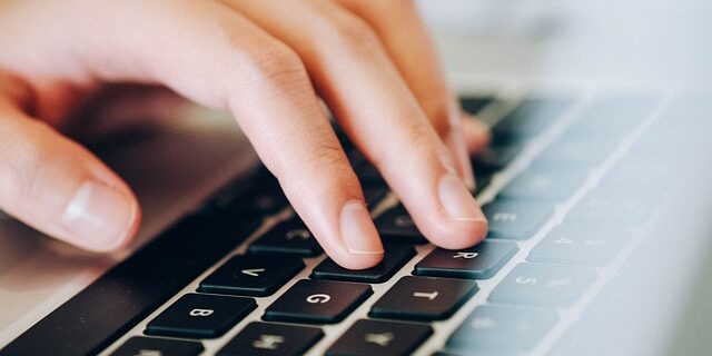 Typing on a laptop